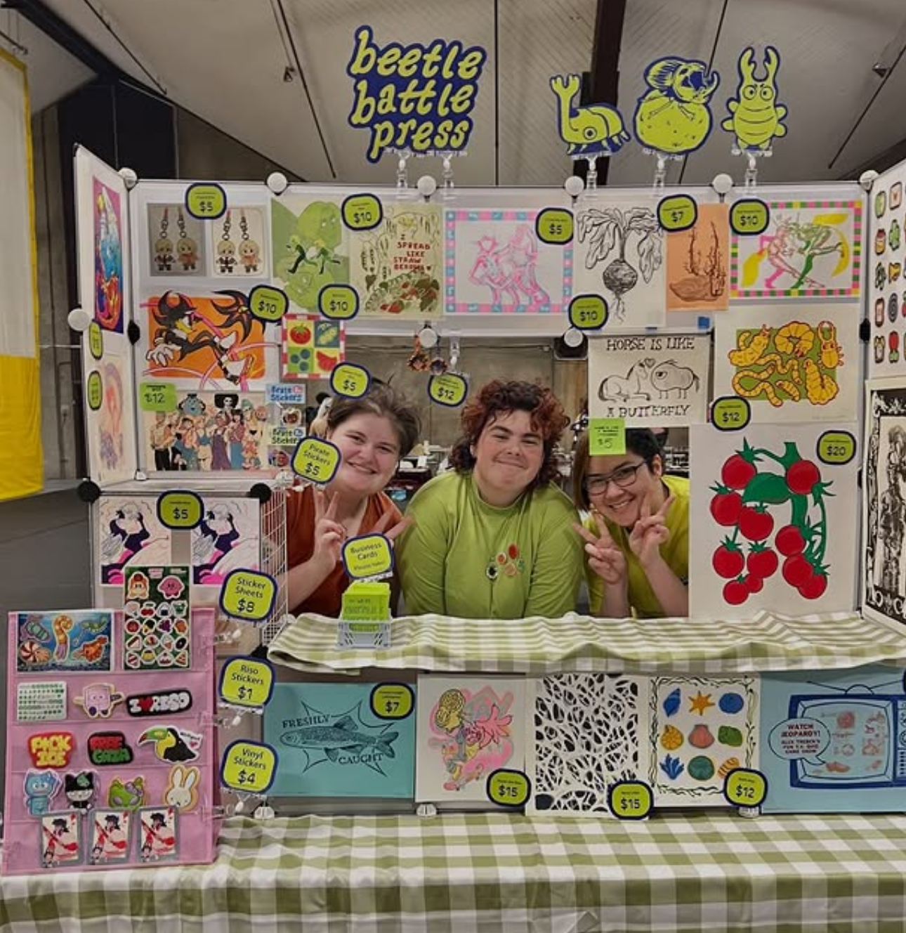 Beetle Battle Press posing at their art vending table at the 2026 Pratt Student Design Marketplace